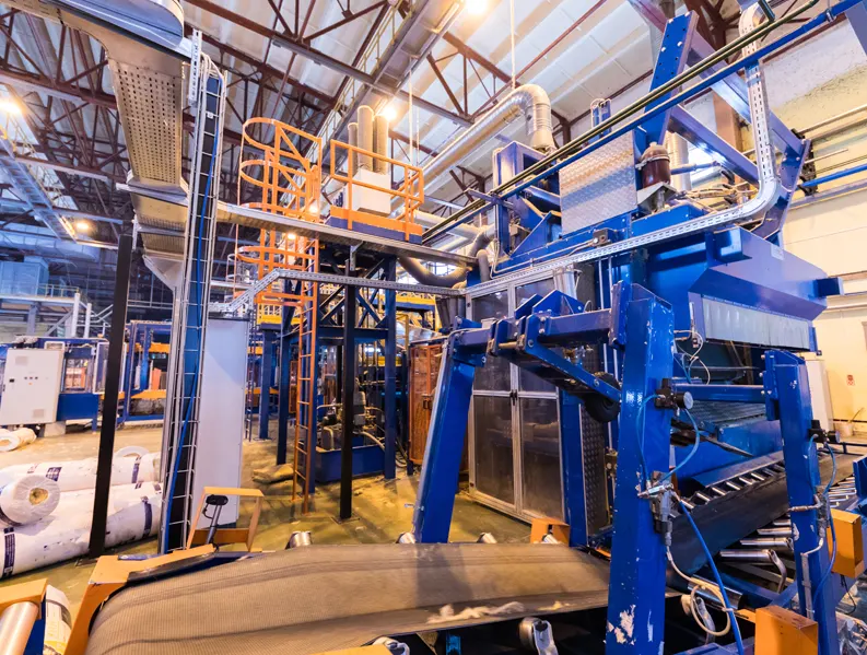 The inside of a factory with a blue machine