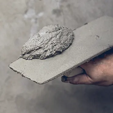 A person is holding a piece of concrete